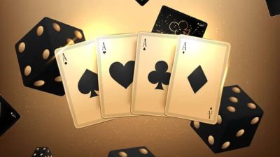 four Aces in a card game, with dice in the background, illustrating the potential for strategic play and answering the question can you play Spades with 3 people.