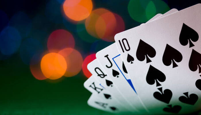 Close-up of Spades cards, showcasing a strong hand with King, Queen, and Jack of Spades, representing the strategies and gameplay involved in how to play Spades with 2 people.