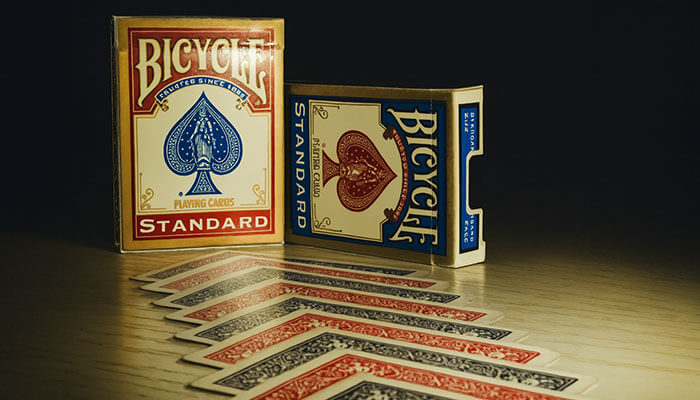 Bicycle playing cards Standard edition with red and blue decks displayed on a wooden surface, showing a neat spread of cards.