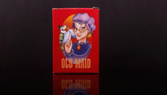 Red old maid card game box with a cartoon elderly woman holding a bird, used in guides on how to play old maid game for family fun.