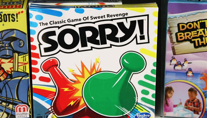 Box cover of the classic Sorry! board game with colorful pawns, used in a guide on how to play Sorry board game.