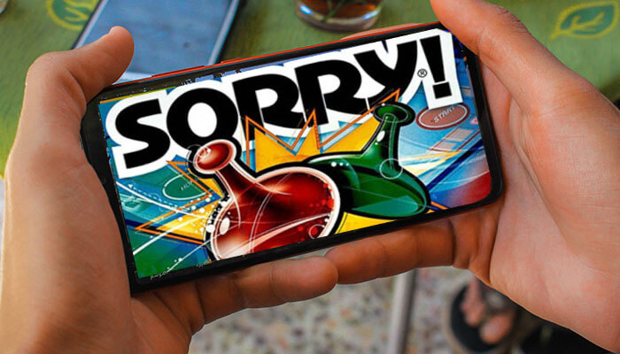 Person holding a smartphone showing the Sorry! board game cover, highlighting digital ways to play sorry board game.