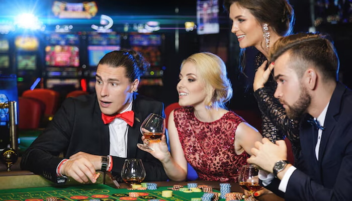 A stylish group of friends playing at a casino table with drinks in hand, illustrating the lively entertainment and community vibe of Spree Casino.