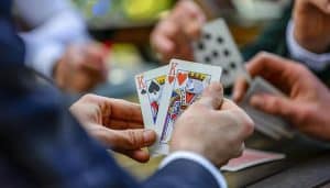 Screw Your Neighbor Card Game Strategies - Live Casino Magic - Live CasinoMagic Two players holding high-ranking cards in a game of Screw Your Neighbor. Understanding the Screw Your Neighbor card game rules is essential for success.
