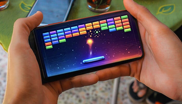 Strategies to get high scores in Google Block Breaker - Live Casino Magic - Live CasinoMagic google block breacker game being played on a smartphone, showing classic brick breaker gameplay with paddle and ball on a mobile device