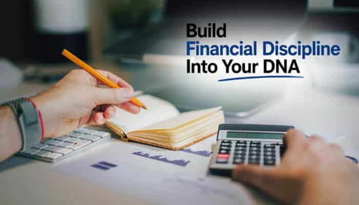 Build Financial Discipline Into Your DNA - Live Casino Magic - Live CasinoMagic Entrepreneur reviewing financial reports, budgeting plans, and expense calculations at a workspace while applying a startup booted fundraising strategy focused on financial discipline, lean startup operations, cash flow management, investor readiness, and sustainable business growth before raising external capital.