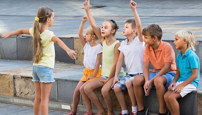 Common Gestures to Remember - Live Casino Magic - Live CasinoMagic How to play charades outdoors with children, one child acting while others eagerly guess the word