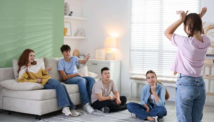 How to Play Charades - Live Casino Magic - Live CasinoMagic How to play charades in a bright living room, with one person acting and others pointing to guess the word