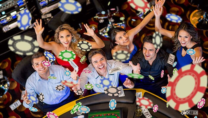 Industry experts at Casino-Groups - Live Casino Magic - Live CasinoMagic Players enjoying an exciting live casino experience with chips, cards, and real-time gaming action
