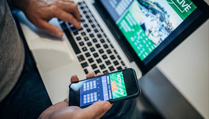 Esports Betting Becoming a Mainstream Product - Live casino magic - Live CasinoMagic User accessing a Nordic online casino and sports betting platform on a smartphone and laptop, showcasing mobile gambling and digital betting technology in the Nordic market.