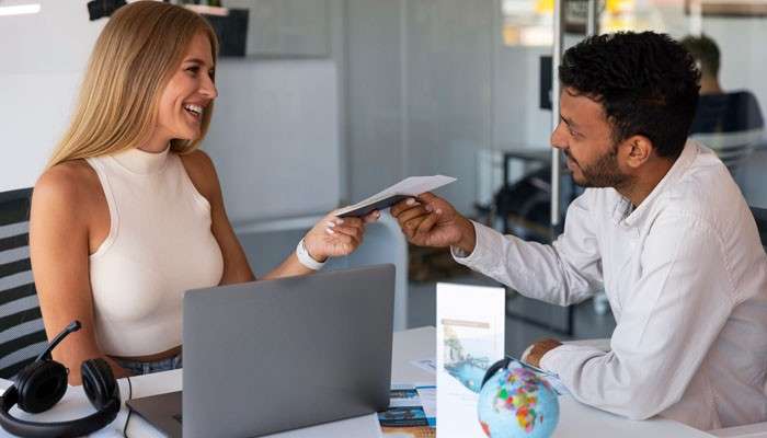 Weeks 78 Manage the final booking period - Live Casino Magic - Live CasinoMagic Site Gamificationsummit Method Ticket Sales showing an event booking consultation with a customer receiving tickets at a desk.